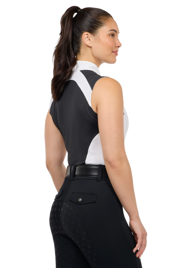 Woman wearing a black and white equestrian outfit on a white background